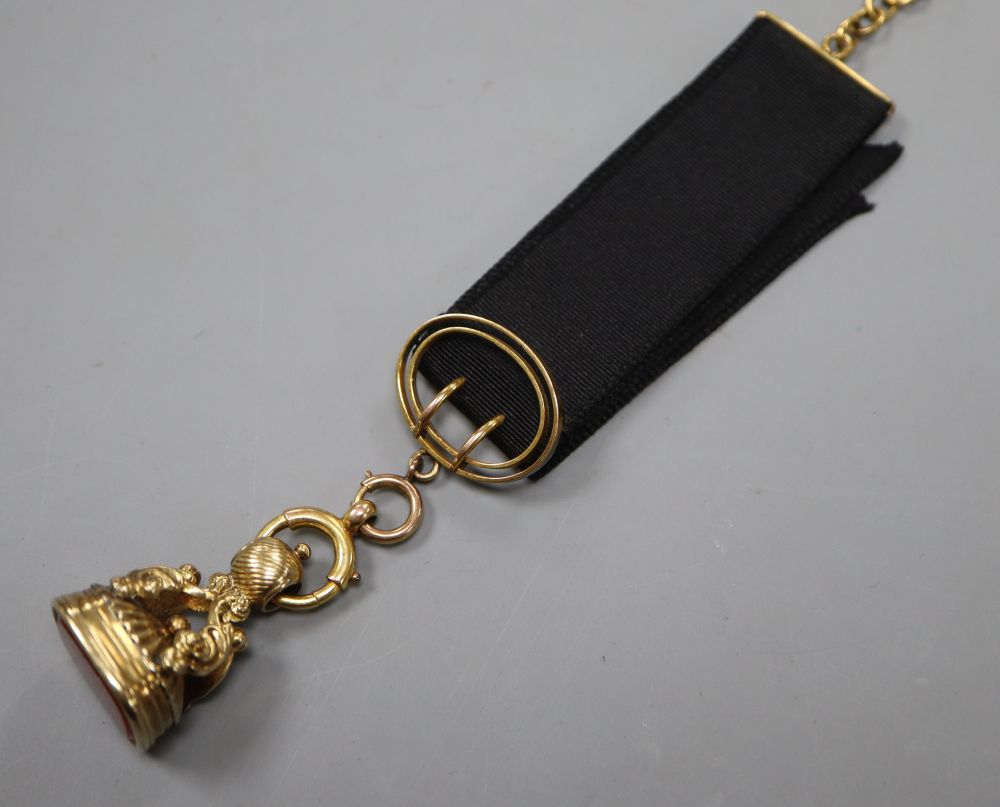 A Victorian yellow metal overlaid and carnelian set fob seal, with 9ct mounted ribbon sash with bale, seal 27mm,